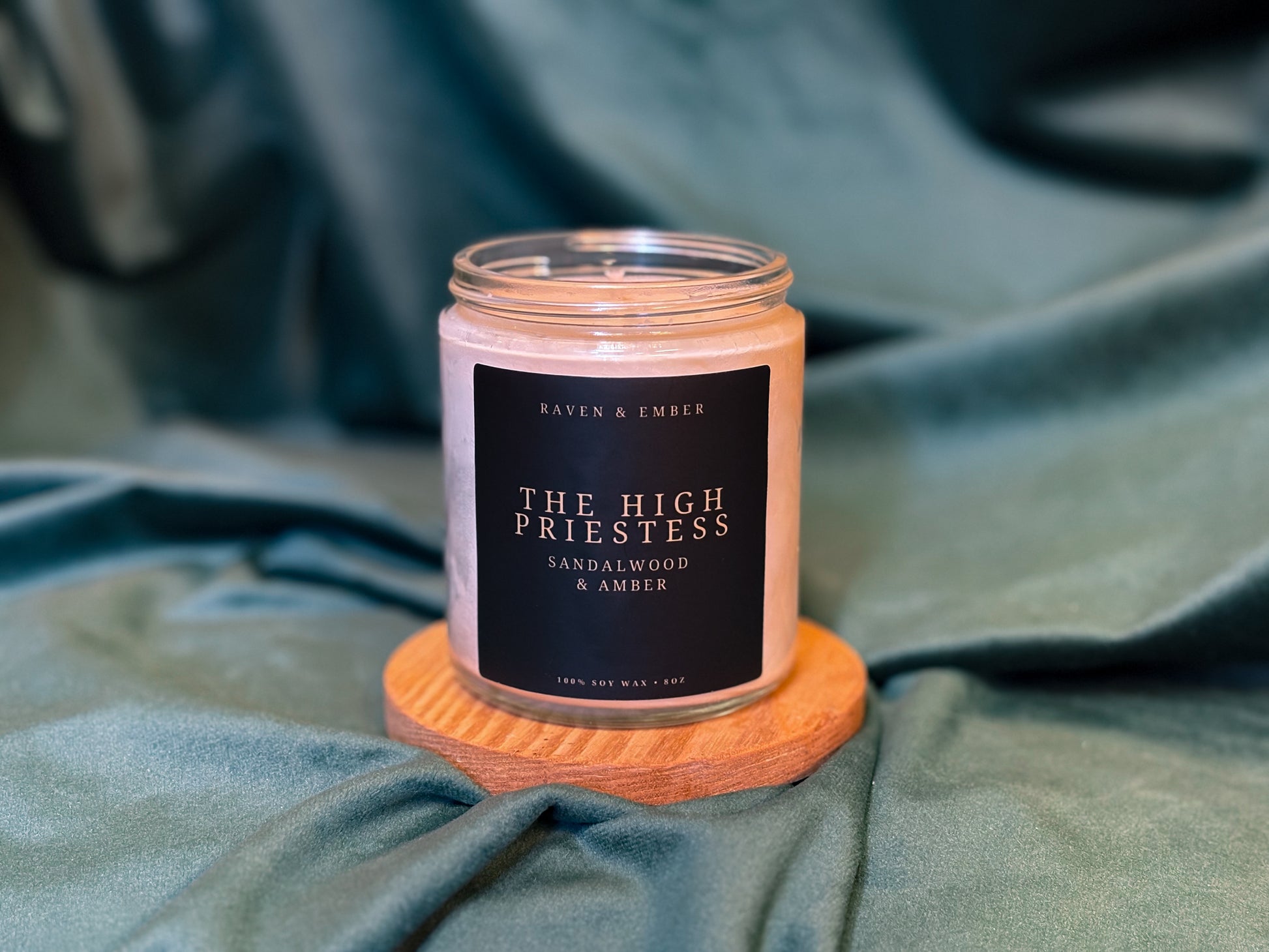 Candle with a label on a textured surface